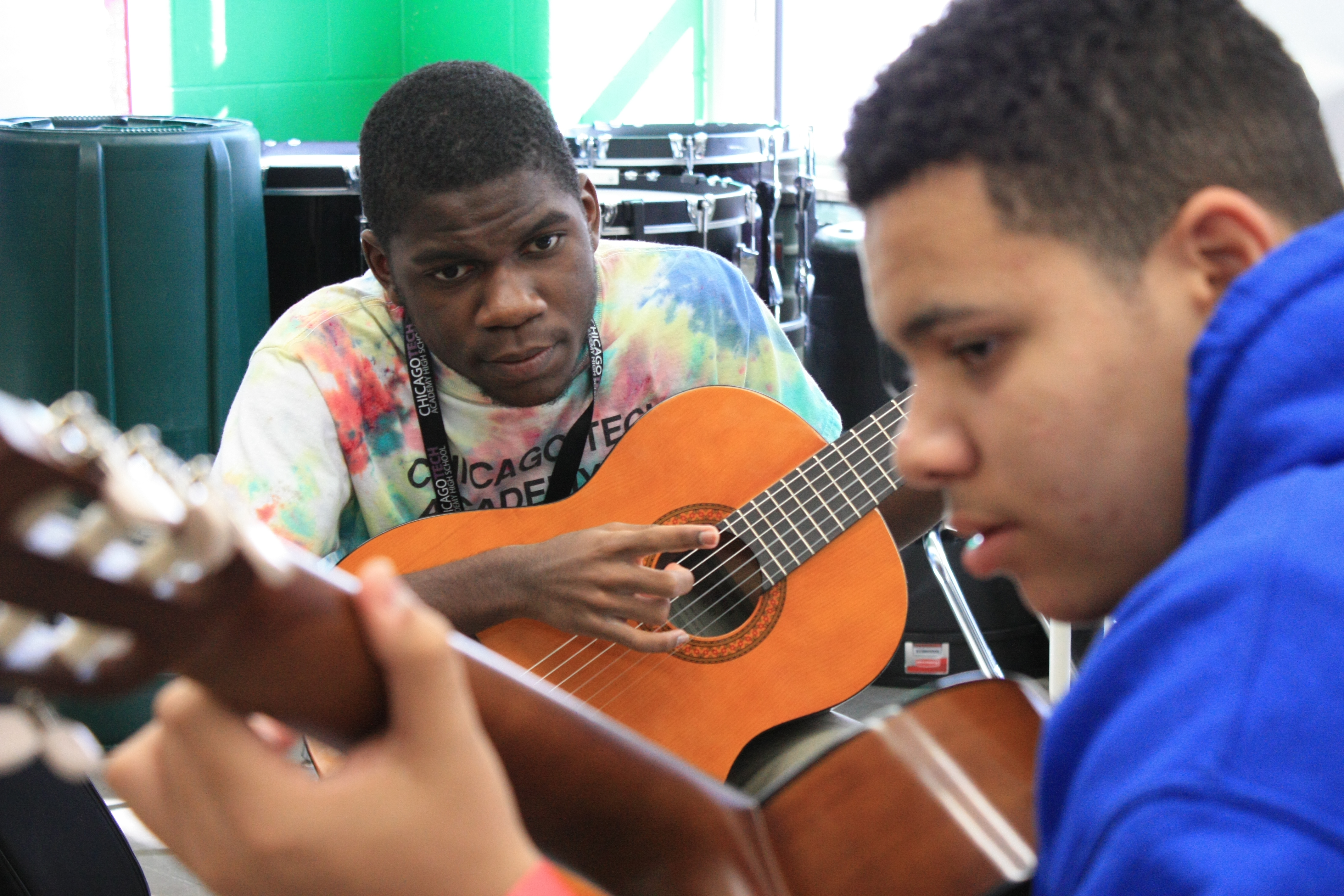 Lead Guitar high school students focus intently on playing a duo