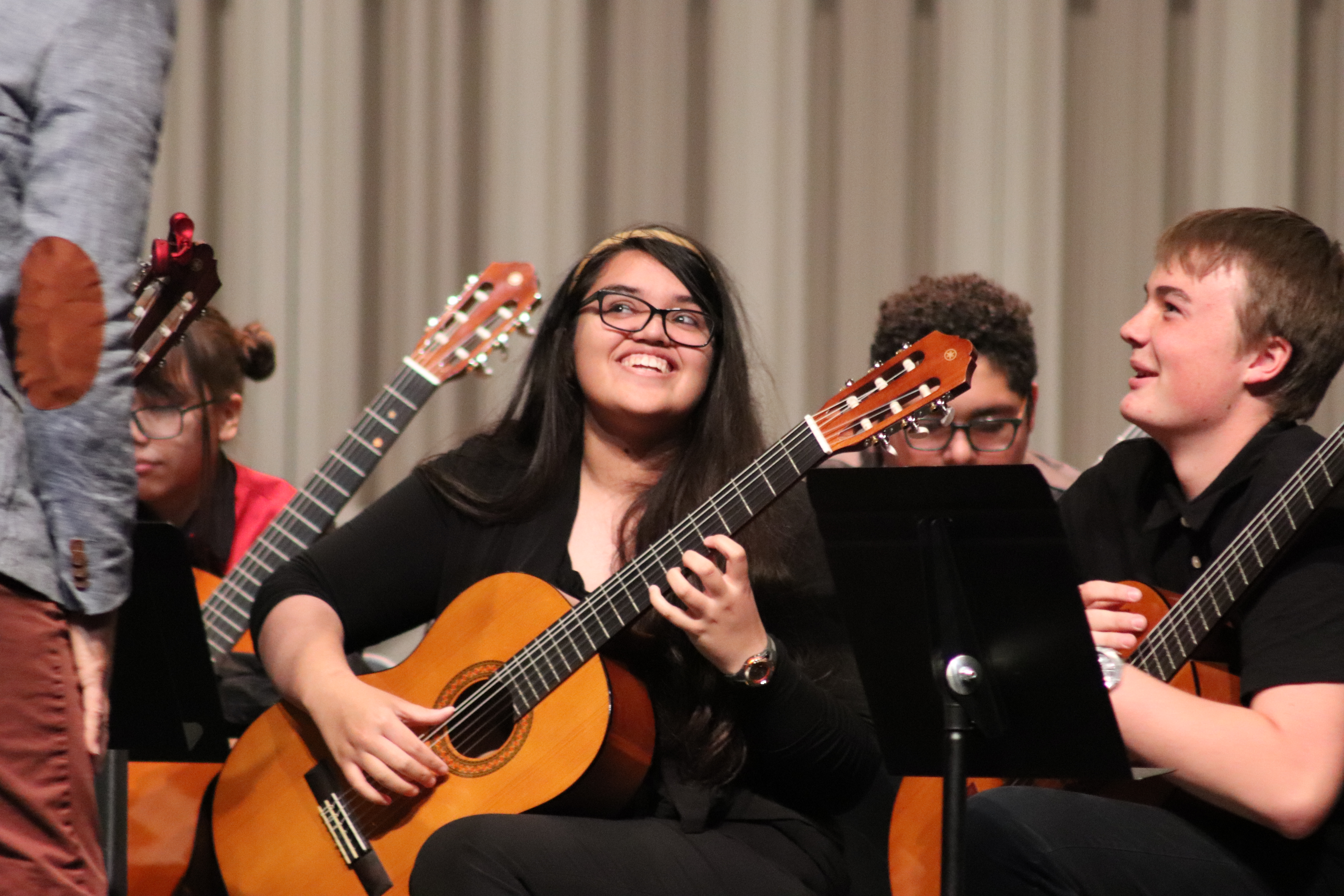 Lead Guitar high school ensemble student smiles during a UArizona performance